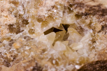 Natural quartz crystals grow from a stone block close up