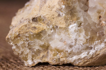 Natural quartz crystals grow from a stone block close up