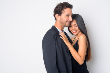 Portrait of happy multi ethnic business couple embracing together