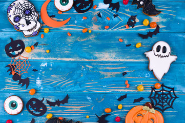 Halloween party content. Halloween gingerbread cookies on the blue wood background.