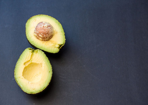 Avocado top view on a dark background .