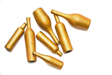 Bottles of different sizes in gold color isolated on a white background.