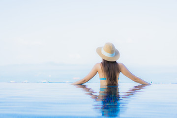 Portrait beautiful young asian women happy smile relax outdoor swimming pool in resort