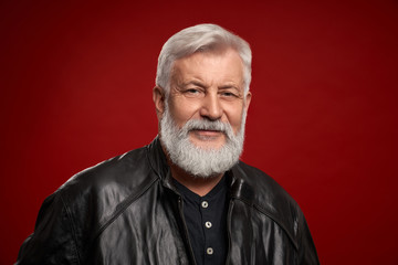 Fototapeta premium Portrait of confident aged man in black leather jacket