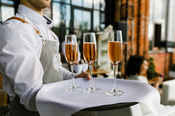 waiter serving red wine in restaurant