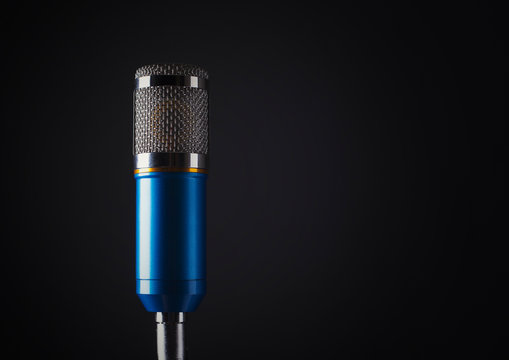 blue metal body microphone dark grey background studio shot
