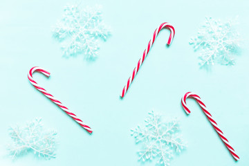 Christmas flat lay background. Gold glitter and festive decor on neo mint background. Christmas...