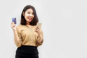 happy Asian woman hand holding mobile phone and credit card for shopping online
