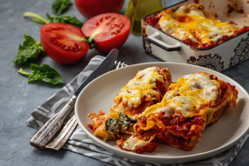 Spinach and ricotta stuffed cannelloni baked  in tomato sauce.