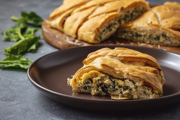 Homemade savory braided puff pastry with spinach and ricotta filling. 