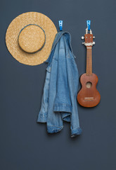ukulele,denim jacket, straw hat on the background