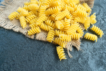 Raw pasta on a black background. Copy space.