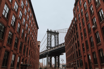 New York, United States of America , Pillar of Manhattan Bridge as seen from an alley in Dumbo...