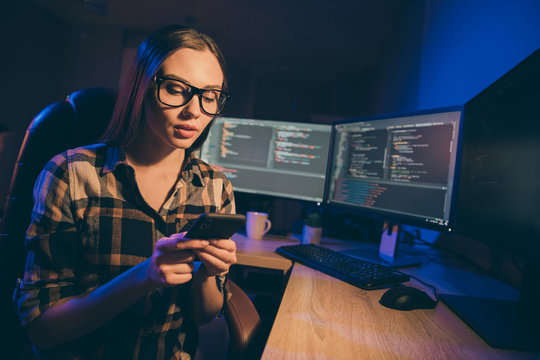 Photo of cute girl wearing spectacles working on startup and project at new generation of information technologies using javascript