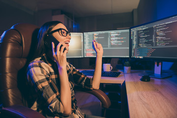 Side profile photo of developer readying to have some rest by speaking on phone during her night...