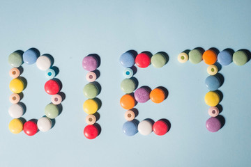 The word diet is laid out from sweets on a blue background