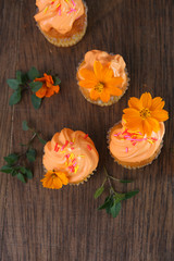 mini cup cakes decorated with whipped cream and sugar sparkles