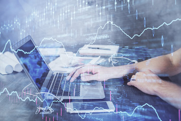 Double exposure of forex chart with man working on computer on background. Concept of market analysis.