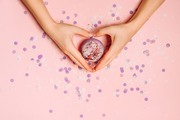 Flat lay photo with bath bomb in hands of girl.
