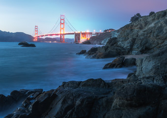 the famous golden gate bridge in san francisco at dawn seen from scenic Baker Beach. blue hour shot.