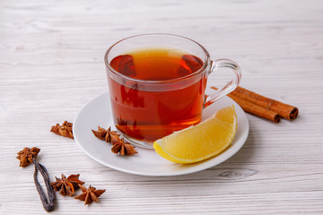 black tea in transparent Cup with lemon on white background