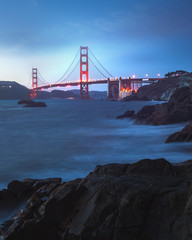 the famous golden gate bridge in san francisco at dawn seen from scenic Baker Beach. blue hour shot.