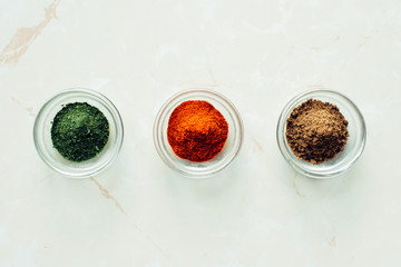 Jars with paprika, coriander and parsley. Spice set.