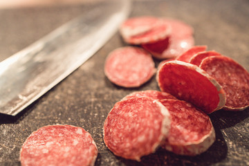 Cut Salami with Knife in background