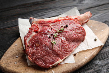 Fresh raw beef cut on wooden table, closeup