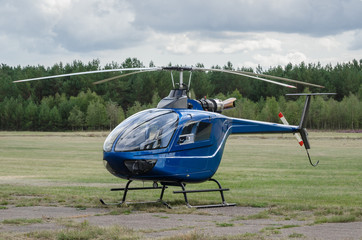 HELICOPTER - A small blue machine  on the airfield