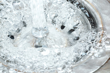 Water bubbles in the sink close up abstract background.