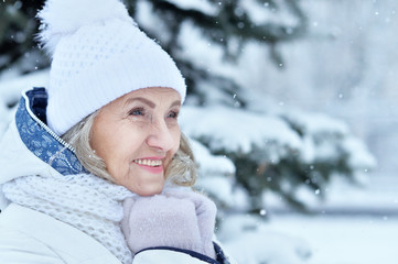 Happy beautiful senior woman in warm hat