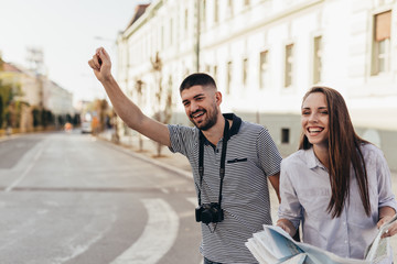 romantic couple tourists calling for a cab
