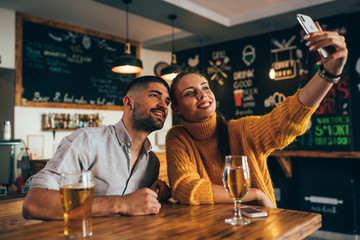 friends having fun taking a picture in bar