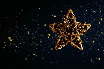 Golden christmas star on black background