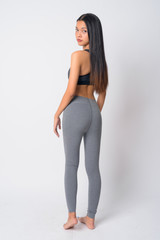 Full body shot rear view of young Asian woman looking over shoulder ready for gym