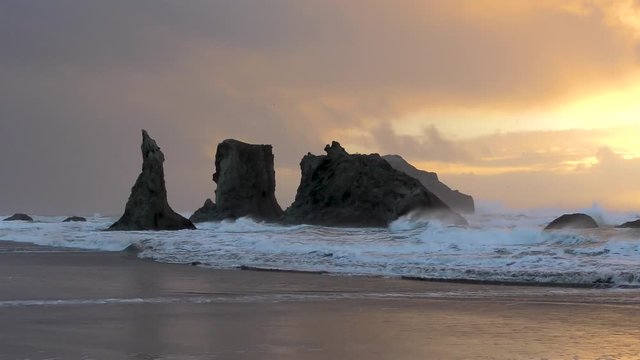Golden waves glimmer and crash over the Bandon beach costline