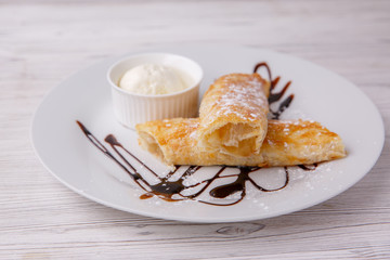 Classic apple strudel with a scoop of ice cream. restaurant menu dessert strudel