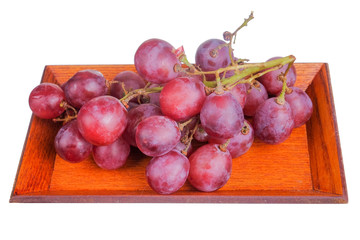 Fresh bunch of grapes on plate isolated on white background