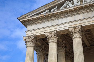 Vintage Old Justice Courthouse Column. Neoclassical colonnade with corinthian columns as part of a public building resembling a Greek or Roman temple