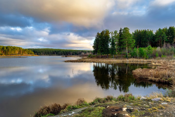 Autumn landscape by the river at sunset. Wonderful nature, beautiful natural background.