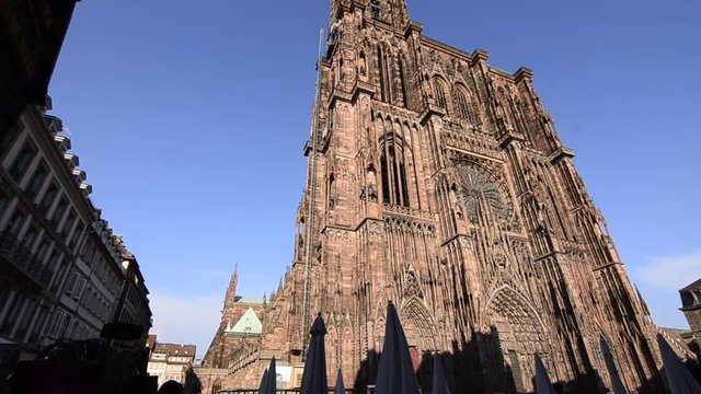 Strasbourg, France.August 2019. Our Lady's magnificent cathedral, with its 142 meters of height, was for comparison time for taller buildings. The reddish fa&ccedil;ade is impressive. Tilt movement.