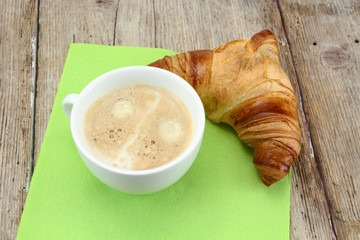 coffe and croissant on a wood table