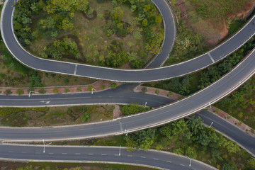 Top view of vehicles driving on densely curved bridge road
