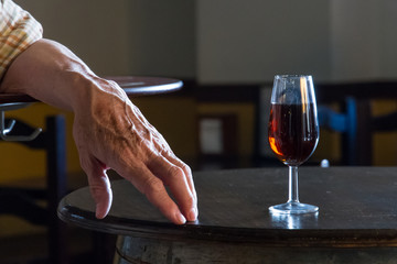 Hand with glass of red wine