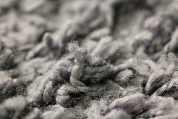 Macro photography of gray carpet long pile. Home textile interior close up