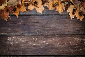 Autumn leaves on wooden wallpaper with copy space. Thanksgiving background