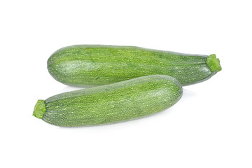 whole fresh zucchini on white background