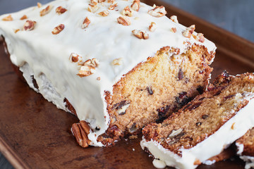 Fototapeta premium Homemade Cranberry Sweet Bread with Pecans and White Chocolate Candy Frosting