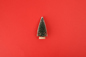 Small christmas tree on red background